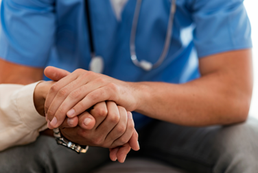 Doctor Holding A Patients Hand In Support
