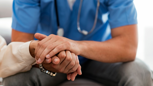 Doctor Holding A Patients Hand In Support