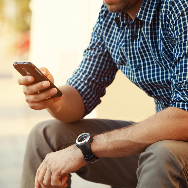 Young Man In Chequered Shirt On Phone