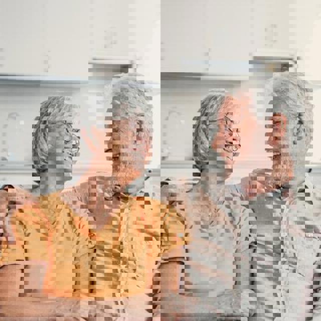 Older Couple Sat On The Sofa
