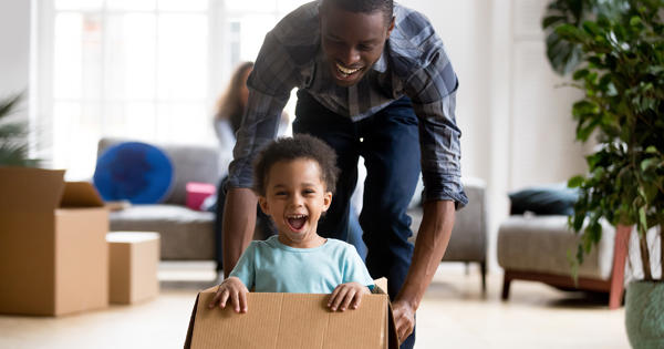 Family Moving In Young Boy In Box