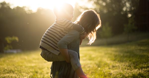 Mum Giving Child A Piggy Back