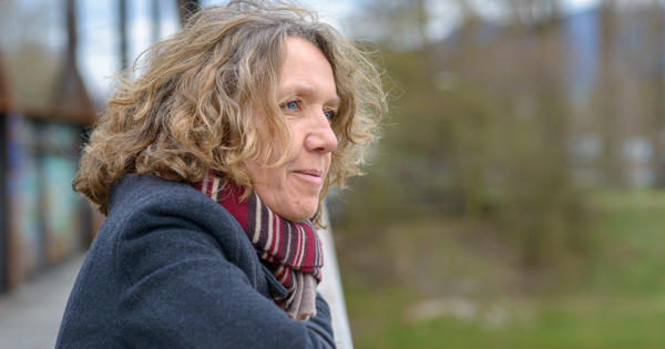 Older Woman Outside Home In Warm Clothes