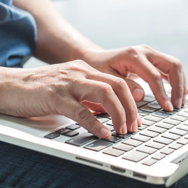 Hands Using Laptop